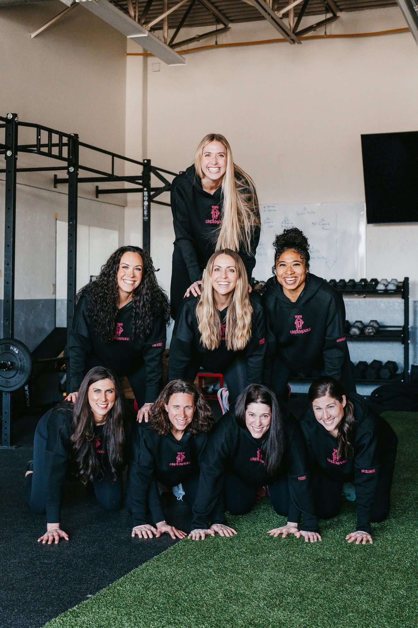 TCF3 team wearing matching Undeniable hoodies in a gym